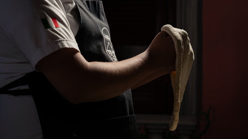 Mod Pizza kitchen team crafting fresh mod pizza with quality ingredients